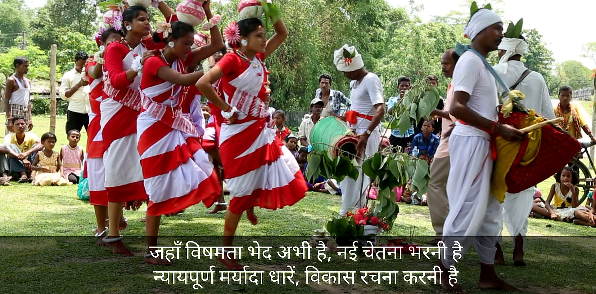 Tribal dancers in red and white at a village festival
